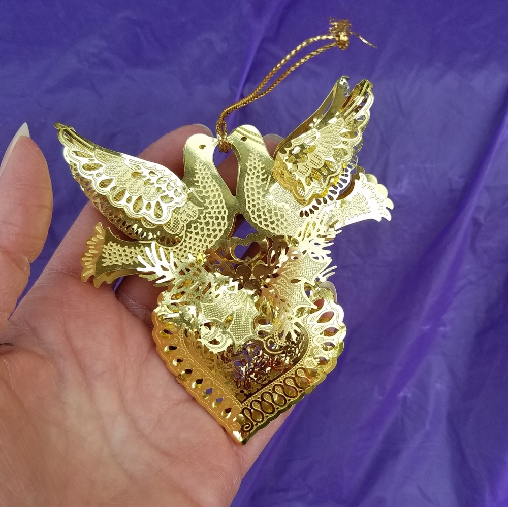 Delicate, metallic ornament, two birds and a heart.